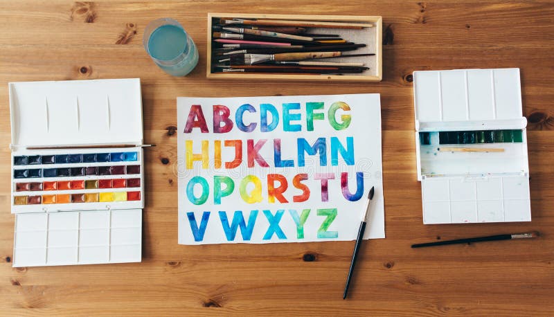 Painter workplace top view. Wooden table of an artist with art tools for drawing. stock image