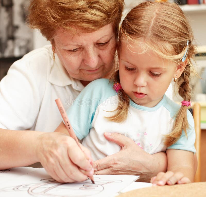 Grandma and grand-daughter painting royalty free stock images.