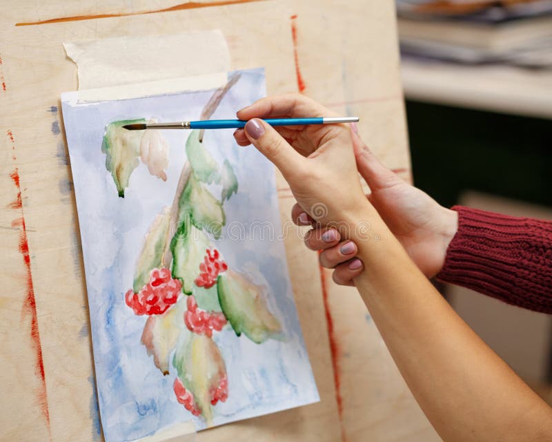 Girl paints still life in watercolor art school. Teacher helps to correct defects in the film. Hands close-up. Courses of drawing for adults. Girl paints still life in watercolor art school. Teacher helps to correct defects in the film. Hands close-up. Courses of drawing for adults.