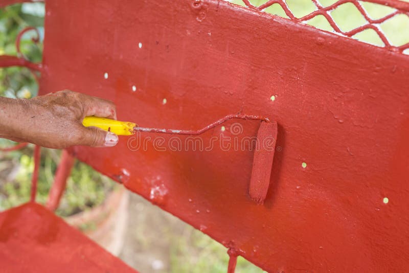 Painting the Back Rest of an Old Glider Swing Made of Wrought Iron with