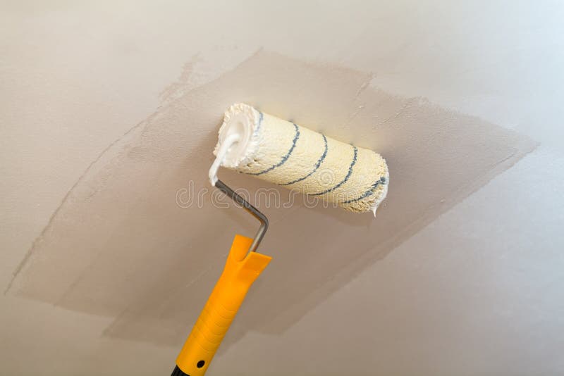 Painting the Ceiling a Roller with White Paint Stock Image Image of