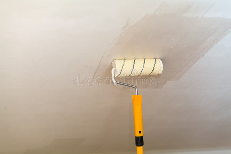 Painting the Ceiling a Roller with White Paint Stock Photo Image of