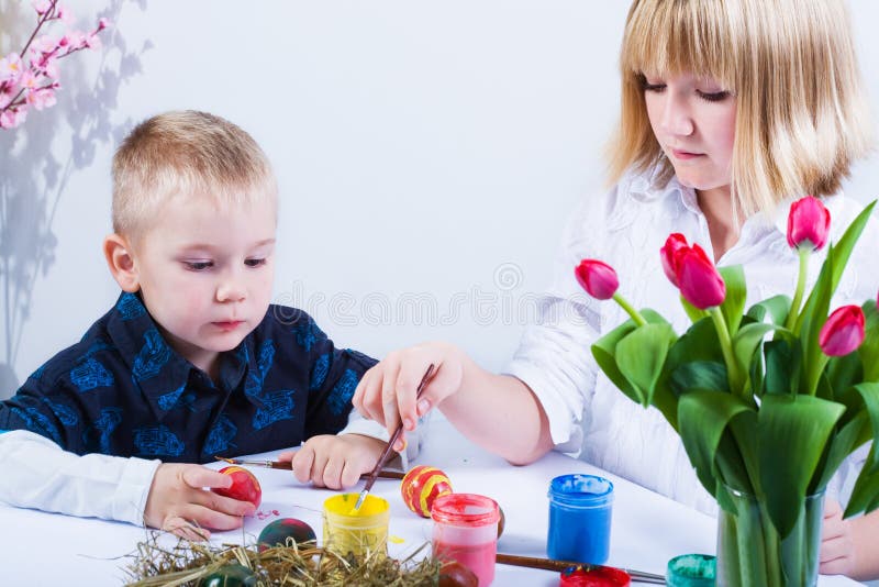 Boy and girl painting easter eggs