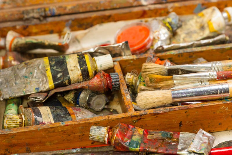 Paints and brushes art supplies in painting studio