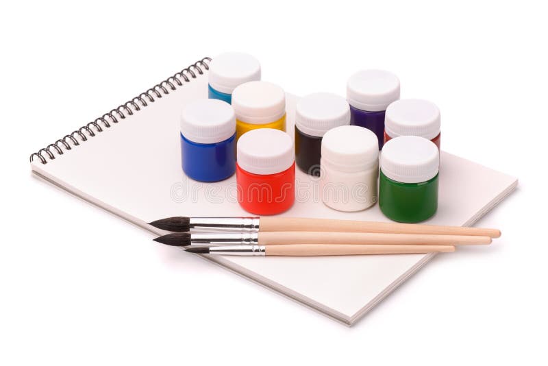 Paints, brushes and sketchbook royalty free stock photography
