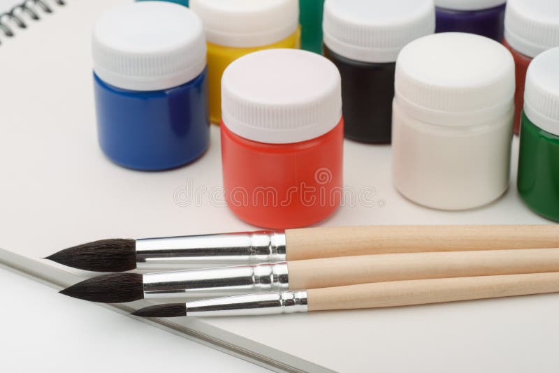 Paints, brushes and sketchbook royalty free stock photos