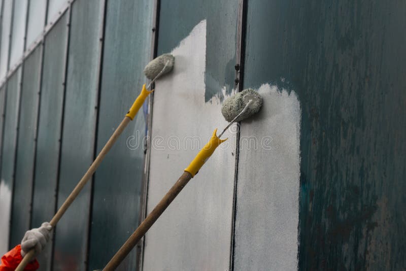 Paints the Graffiti with a Roller Stock Photo Image of floor, blue
