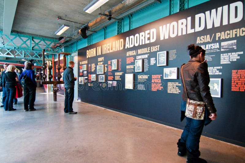 Tourists watching a history panels in Guinness Storehouse in Dublin, Ireland, where the Guinness beer is made. It was found by Arthur Guinness in 1759. Tourists watching a history panels in Guinness Storehouse in Dublin, Ireland, where the Guinness beer is made. It was found by Arthur Guinness in 1759.