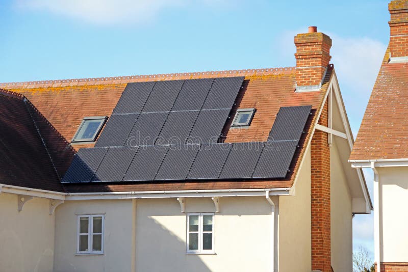 Photo of rooftop solar panels on modern eco house ideal for technology,green living etc. Photo of rooftop solar panels on modern eco house ideal for technology,green living etc.