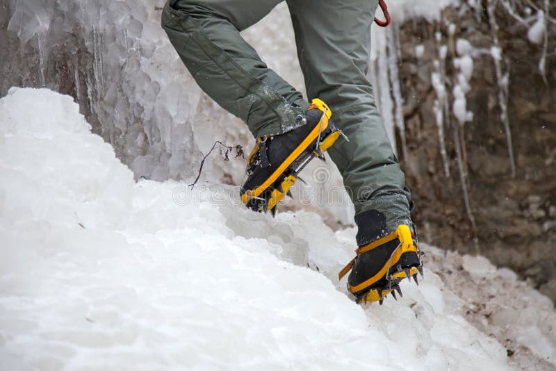 Crampons closeup. Crampons closeup. Crampon on winter boot for