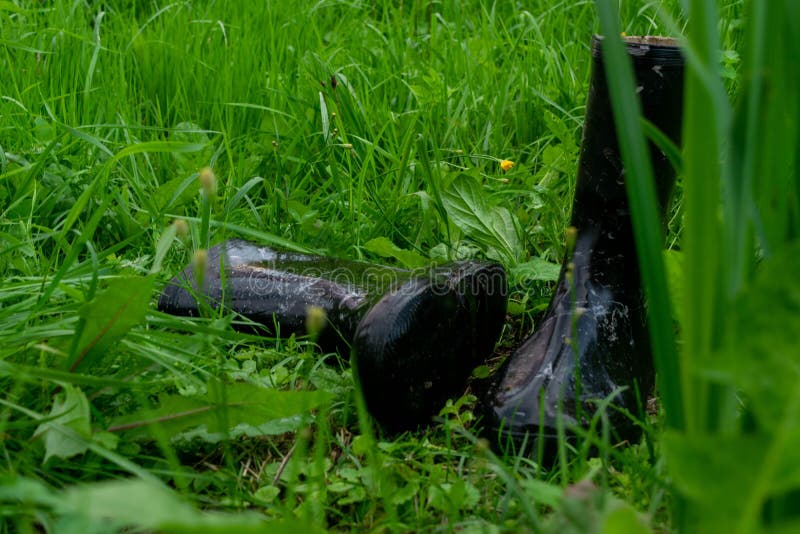 A Pair of Black Rubber Boots in the Green Grass Stock Image Image of