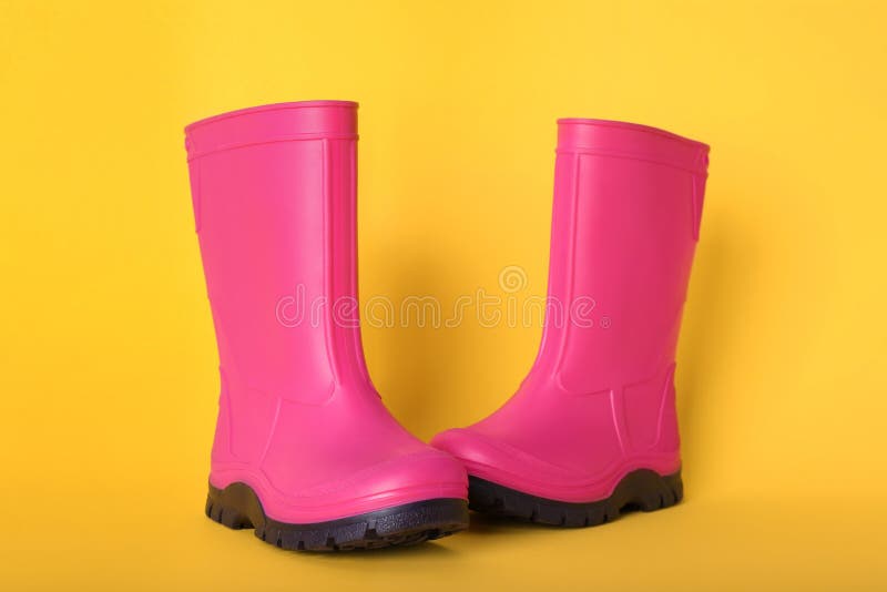 Pair of Bright Pink Rubber Boots on Pale Orange Background Stock Photo ...