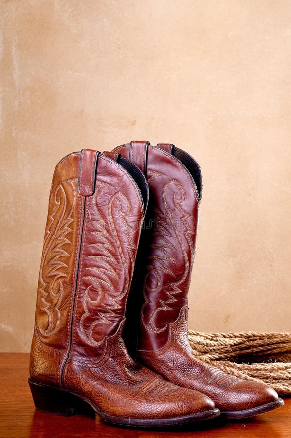 A pair of brown cowboy boots rope