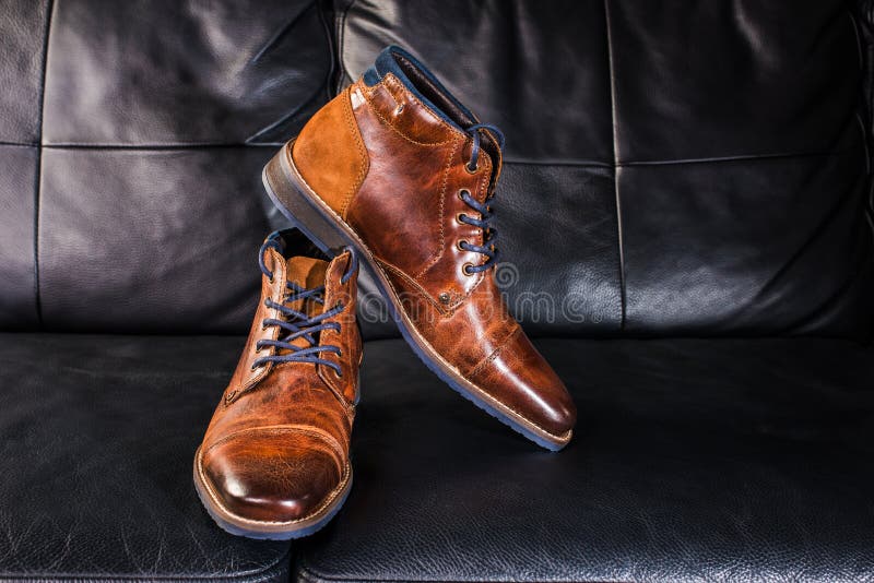 Brown Leather Shoes Displayed on Black Leather Sofa Stock Image - Image ...