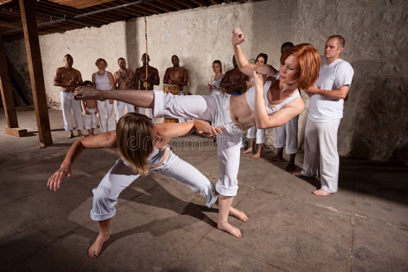 Capoeira bojové umění předvádění techniky na betonové podlaze.