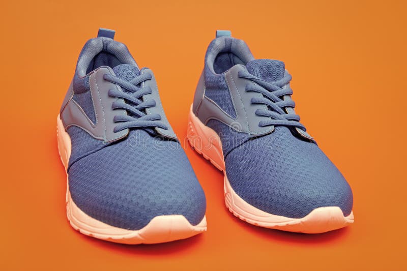 Pair of Comfortable Blue Sport Shoes on Orange Background, Jogging ...