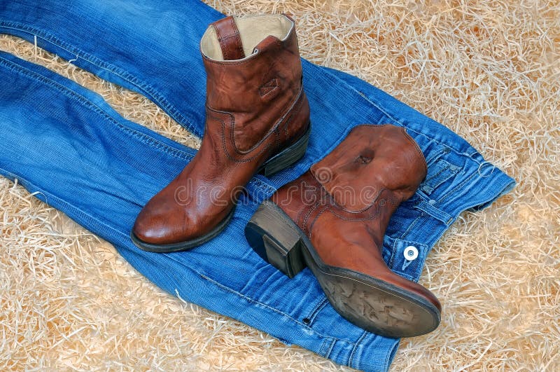 Pair of Cowboy Boots and Blue Jeans on Straw Stock Image - Image of ...