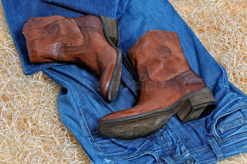 Pair of Cowboy Boots and Blue Jeans on Straw Stock Photo - Image of ...