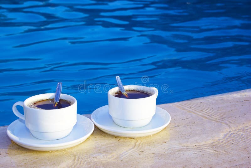 A pair of cups on the poolside