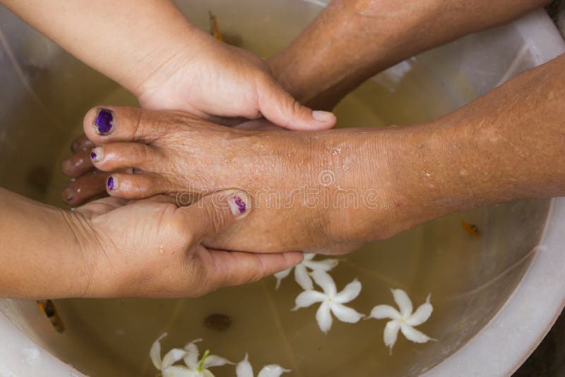 A pair of feet in a bowl full of water royalty free stock photo A pair of feet in a bowl full of water royalty free stock photo