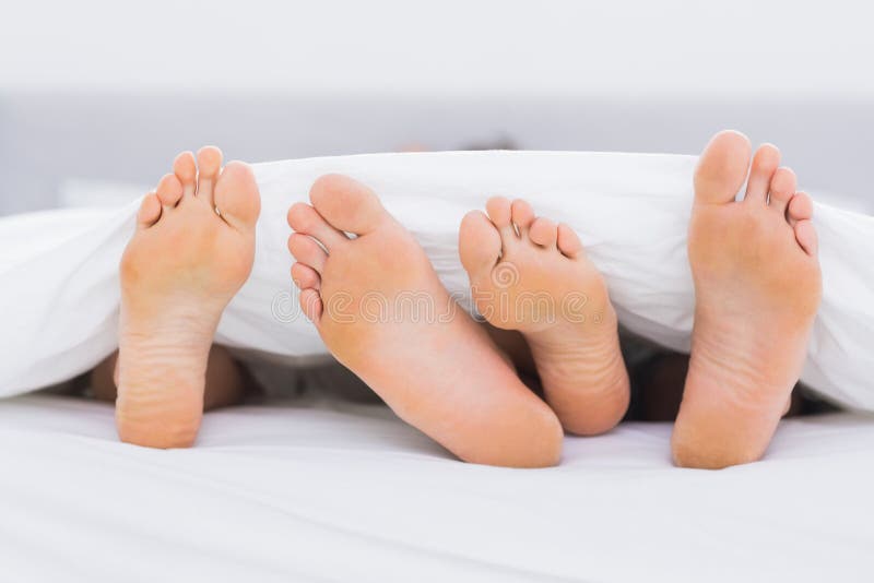 Pair Of Feet Under The Covers Stock Photo Image 32512260