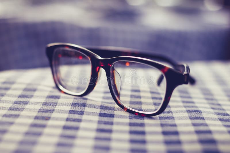 Pair of glasses on a checkered table cloth