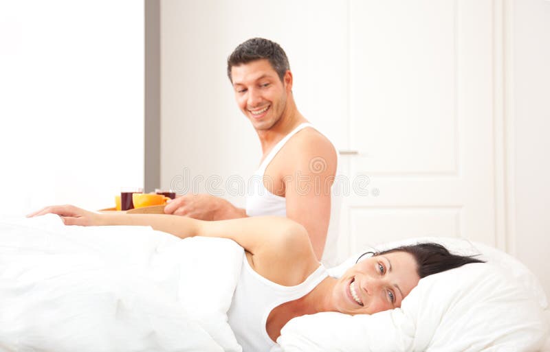 Pair having breakfast in bed