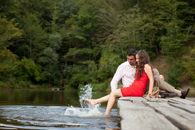 A pair of lovers people sit on the bridge