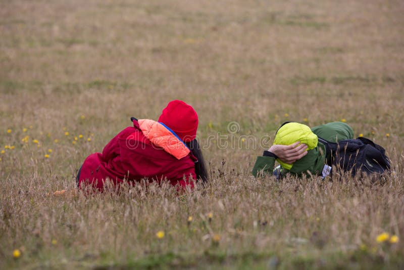 The pair, a man and a woman, lying around on the yellow grass royalty free stock photography The pair, a man and a woman, lying around on the yellow grass royalty free stock photography