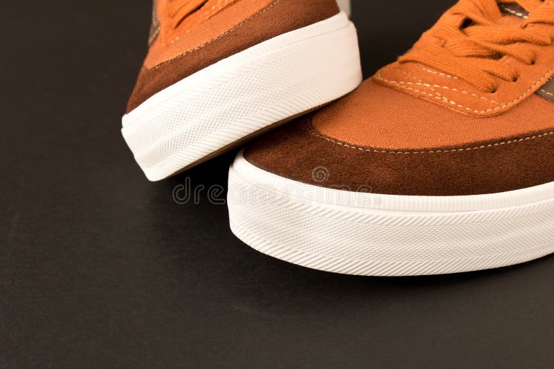 A pair of new sneakers on a dark background. Empty text space royalty free stock photo A pair of new sneakers on a dark background. Empty text space royalty free stock photo