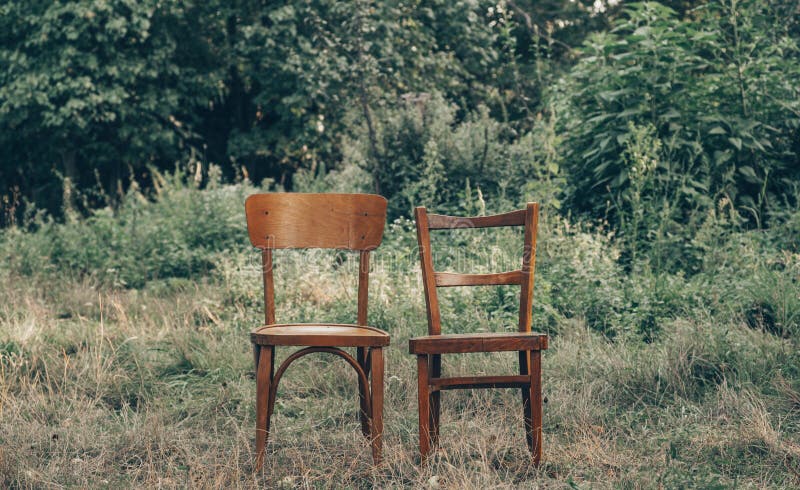 Wooden chair, wooden chair twin, Pair old wooden chair outdoors. Around the lush grass, The environment offers privacy.