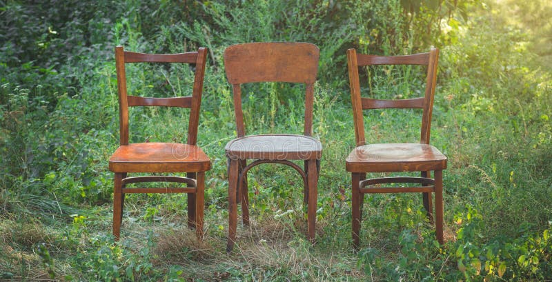 Pair old wooden chair outdoors. Two wooden folding chairs for rest.