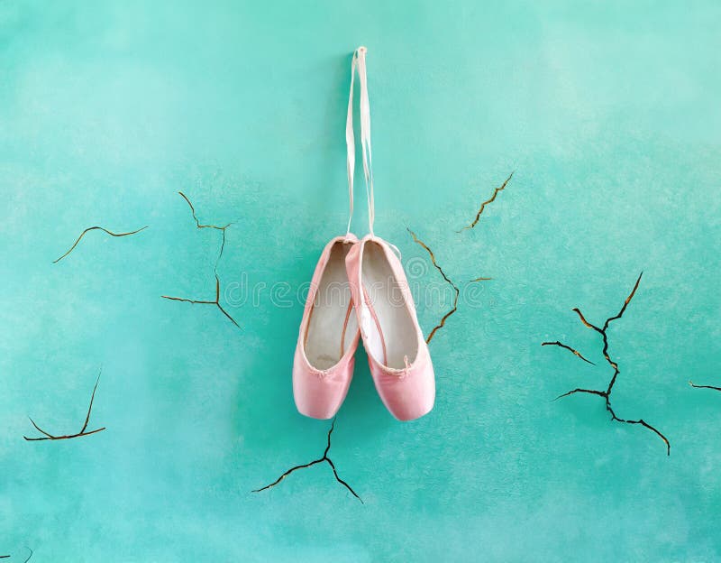 Pair of pink ballet slippers hanging from cords on a light blue wall with cracks stock illustration