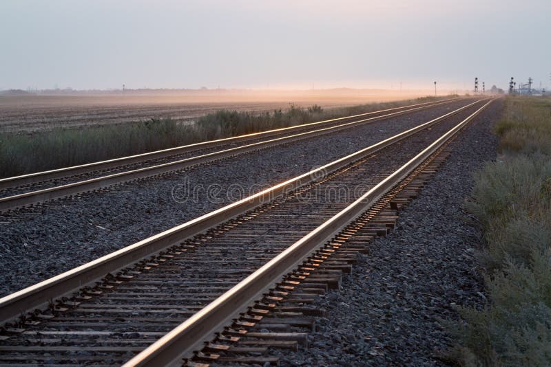 Empty Pair of Railroad Tracks at Sunrise on the Prairie. Pair of Railroad Tracks at Sunrise on the Prairie royalty free stock images Empty Pair of Railroad Tracks at Sunrise on the Prairie. Pair of Railroad Tracks at Sunrise on the Prairie royalty free stock images