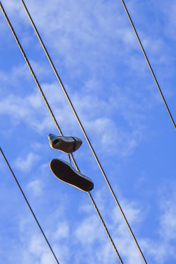 A Pair of Shoes on Electro Wire Tower Stock Photo Image of field