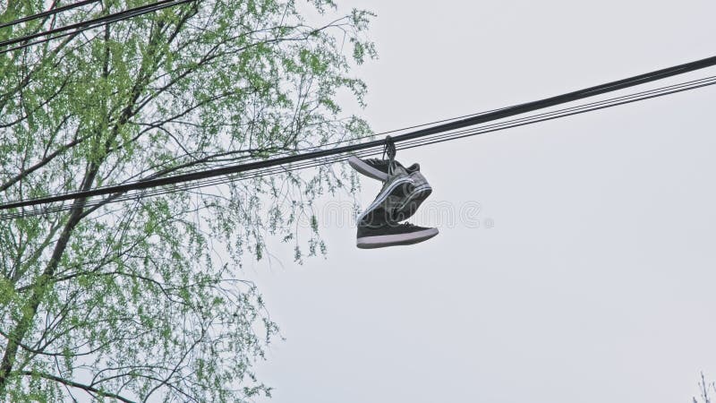 Neighbors concerned about the meaning of shoes on a powerline