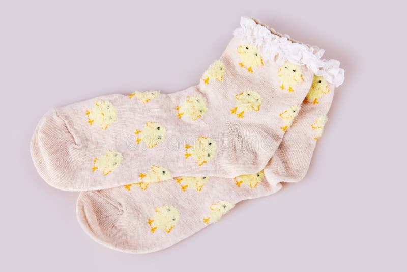 Pair of socks with chicken pattern on the white background.