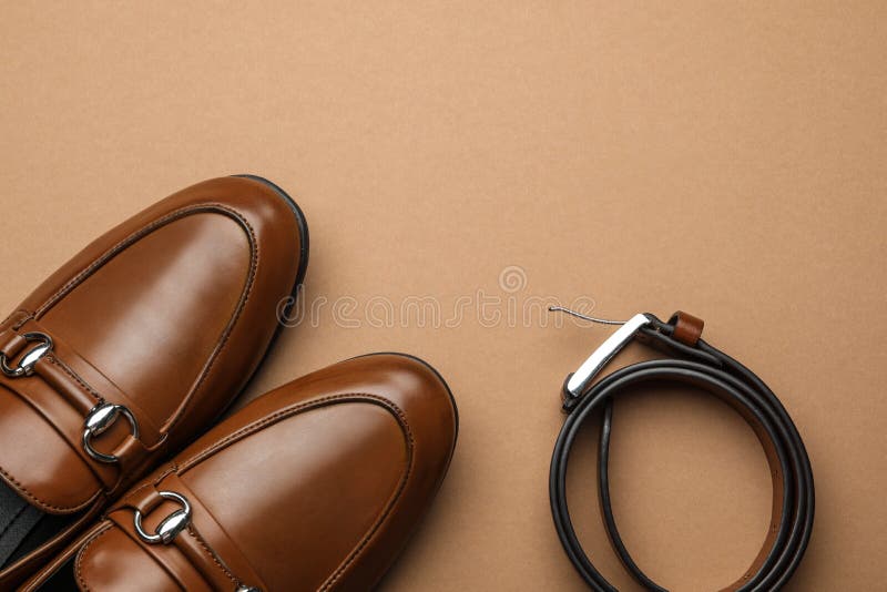 Pair of stylish male shoes and leather belt on background, flat lay