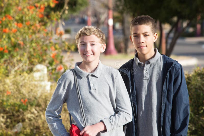 Pair of teen male students outside