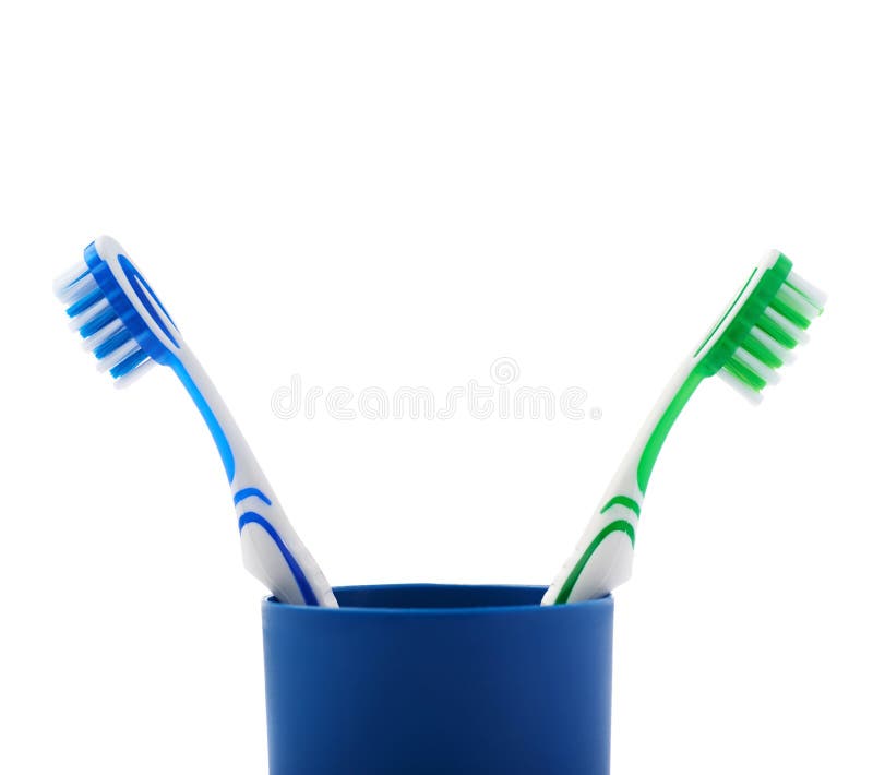 Pair of Toothbrushes in Blue Plastic Cup Isolated Over White Background