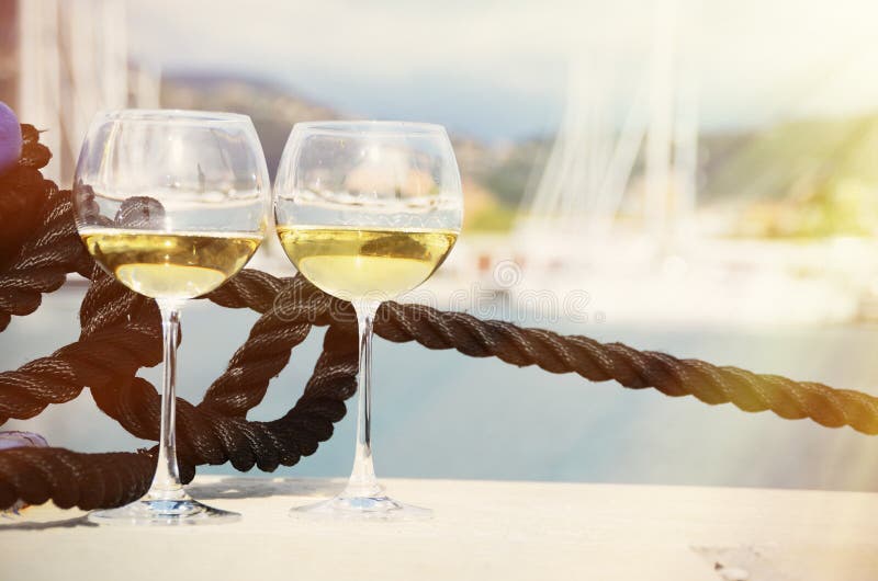 Pair of wineglasses against yachts