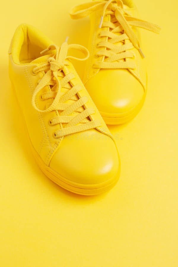 Pair of Yellow Shoes on Yellow Background. Stock Image - Image of ...