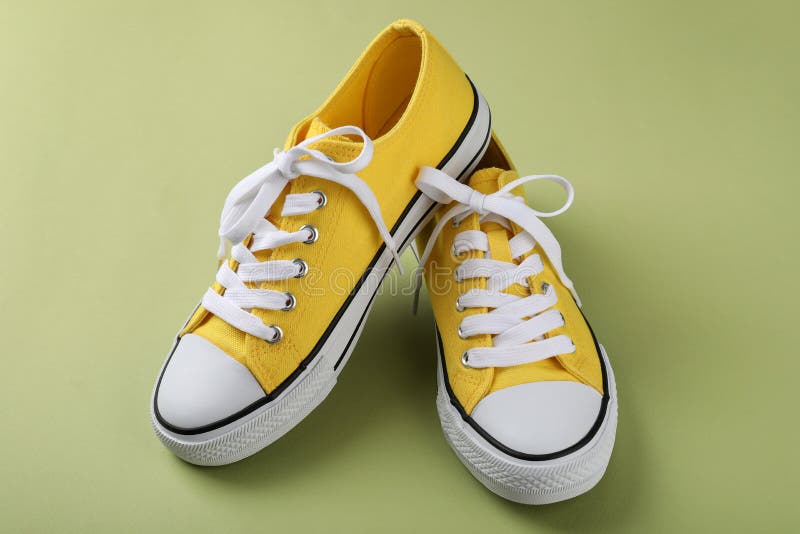 Pair of Yellow Sneakers on Green Background Stock Image Image of