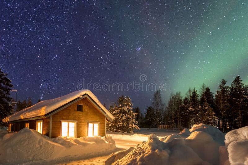 Winter landscape with wooden house under a beautiful starry sky and Northern Lights, Sweden. Winter landscape with wooden house under a beautiful starry sky and Northern Lights, Sweden