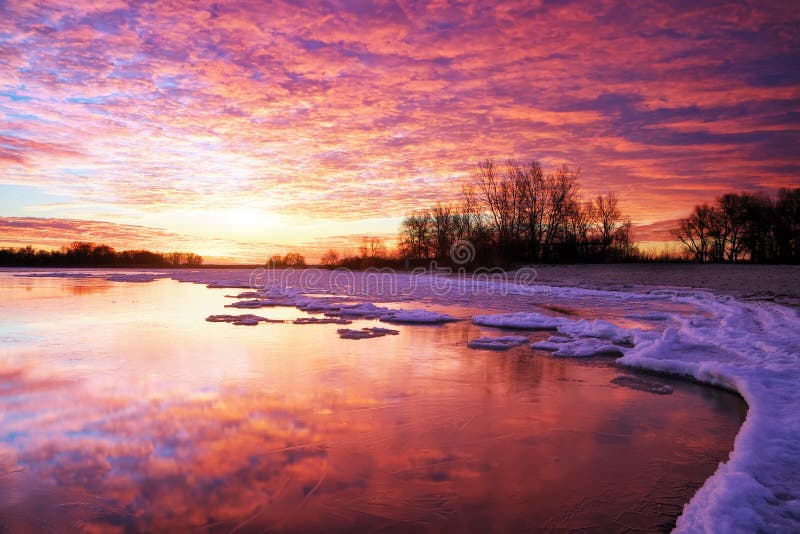 Winter landscape with lake and sunset fiery sky. Composition of nature. Winter landscape with lake and sunset fiery sky. Composition of nature.