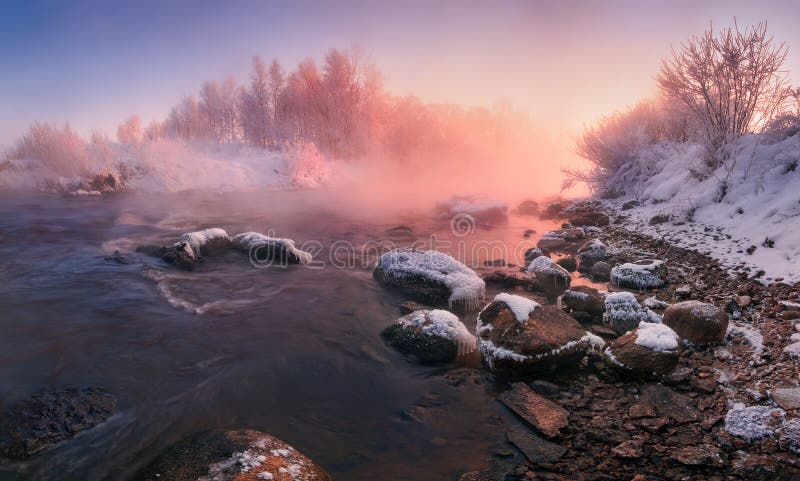 Winter Landscape In Pink Tones: Frosty Morning, River Blurred Water,Stones In Frazil And Sun In Fog.Belarus Landscape With Snowy Trees, Beautiful Frozen Foggy River And Winter Forest At Sunrise. Winter Landscape In Pink Tones: Frosty Morning, River Blurred Water,Stones In Frazil And Sun In Fog.Belarus Landscape With Snowy Trees, Beautiful Frozen Foggy River And Winter Forest At Sunrise.