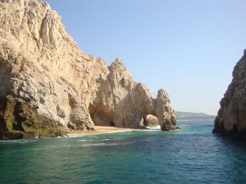 A view of a rugged rocky landscape with El Arco where the Pacific Ocean meets the Sea of Cortez in Los Cabos, Cabo San Lucas, Mexico. A view of a rugged rocky landscape with El Arco where the Pacific Ocean meets the Sea of Cortez in Los Cabos, Cabo San Lucas, Mexico