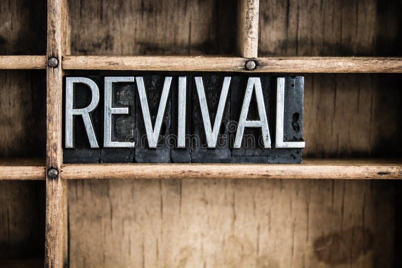 The word REVIVAL written in vintage metal letterpress type in a wooden drawer with dividers. The word REVIVAL written in vintage metal letterpress type in a wooden drawer with dividers.