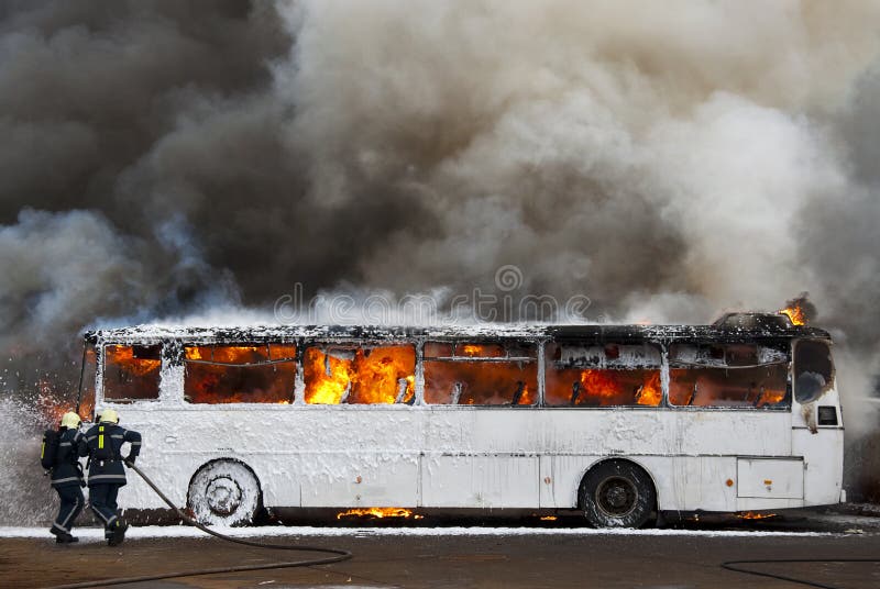 Firemen fighting a bus fire. Firemen fighting a bus fire.