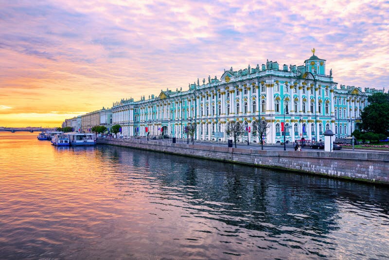 Winter Palace building housing Hermitage museum reflects in Neva river on dramatic sunrise, St Petersburg, Russia. Winter Palace building housing Hermitage museum reflects in Neva river on dramatic sunrise, St Petersburg, Russia